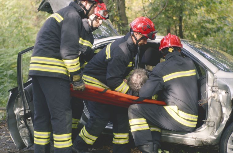 Emergency crews assisting a crash victim